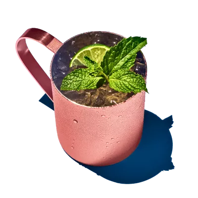 A moscow mule drink in a classic copper mug.